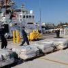 Crewmembers off-load 2500 lbs of cocaine from Coast Guard Cutter Sitkinak. Photo by Petty Officer 1st Class Crystalynn Kneen